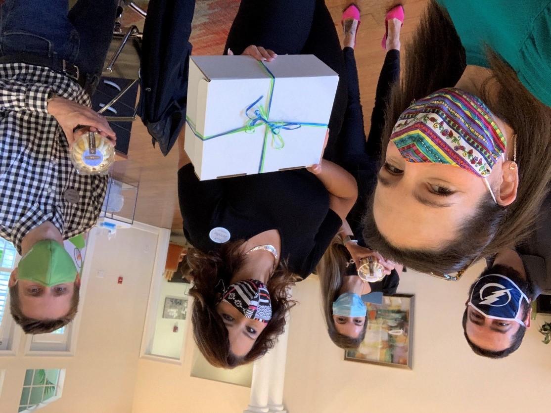 team members holding box of treats