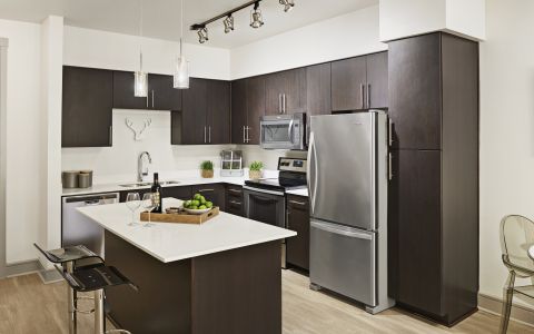 Living Room, Dining Room, and Kitchen at Camden Belmont Apartments in Dallas, Texas