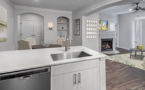 Apartment kitchen with quartz countertops and stainless steel appliances at Camden Manor Park in Raleigh, North Carolina