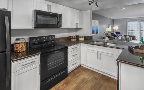 Kitchen with granite countertops at Camden Sea Palms Apartments in Costa Mesa, California