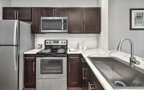 Kitchen with stainless steel appliances at Camden Westwood apartments in Morrisville, NC