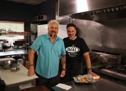 • Chef George Patti and Guy Fieri on set for Diners, Drive-ins and Dives (Season 24, Episode 8: “Hot Meat and Cool Veg” aired April 22, 2016) pictured with Housemade Pork Rinds and Chimichurri Aioli; photo courtesy of M.E.A.T. Eatery And Taproom • Chef George Patti and Guy Fieri on set for Diners, Drive-ins and Dives (Season 24, Episode 8: “Hot Meat and Cool Veg” aired April 22, 2016) pictured with Housemade Pork Rinds and Chimichurri Aioli; photo courtesy of M.E.A.T. Eatery And Taproom