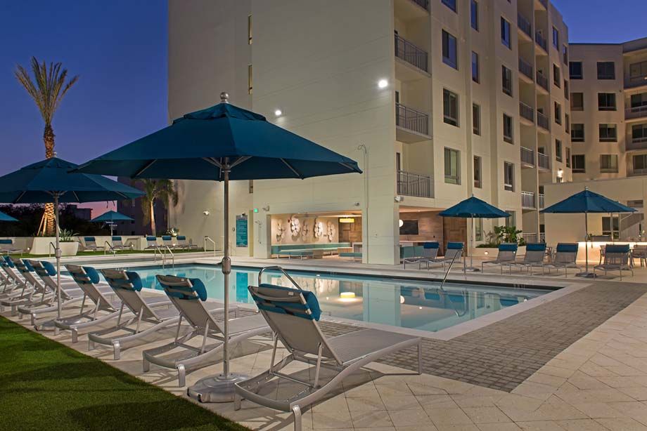 Resort-style swimming pool with lounge chairs at Camden Thornton Park apartments in Orlando, FL