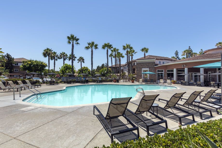 Resort-style swimming pool with lounge chairs at Camden Sierra at Otay Ranch apartments in Chula Vista, CA