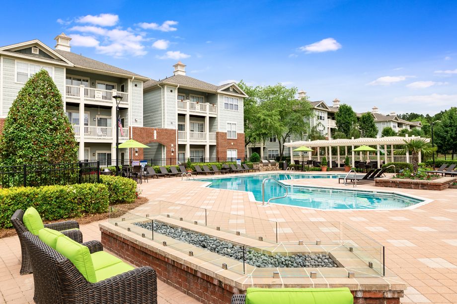 Resort-style swimming pool with outdoor fire place at Camden Governors Village Apartments in Chapel Hill, NC