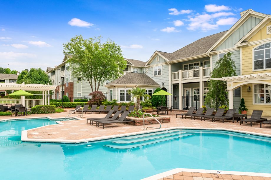Resort-style swimming pool and clubhouse at Camden Governors Village Apartments in Chapel Hill, NC