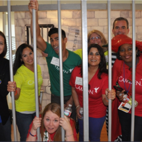 Camden employees pretending to be behind bars during a corporate event in Houston, Texas