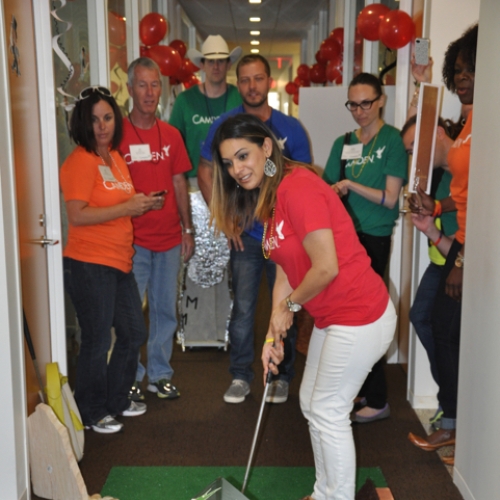 Camden employees competing in a miniature golf game at the corporate office in Houston, Texas